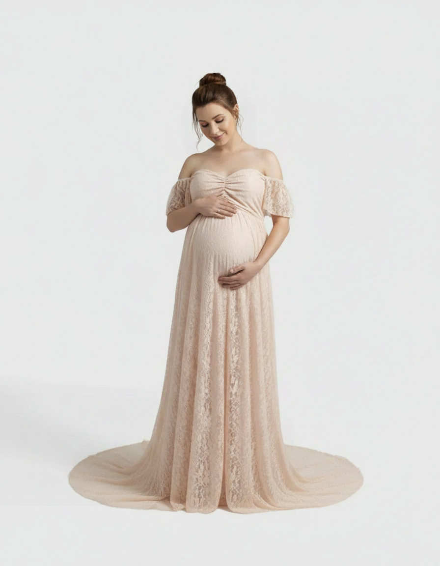 Pregnant woman in a flowing, off-shoulder, light pink lace maternity maxi dress.