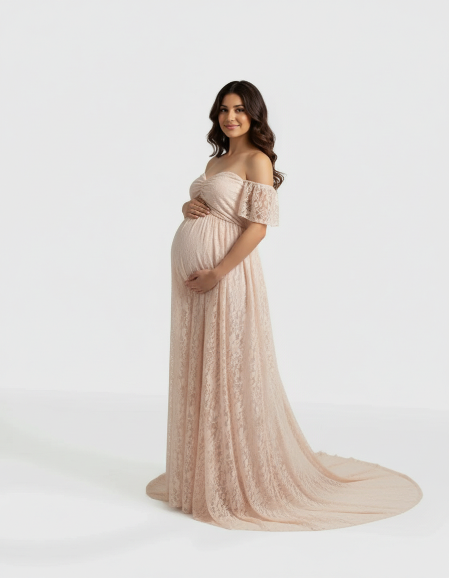 Pregnant woman in a flowing, off-shoulder blush lace maternity maxi dress with a long train.