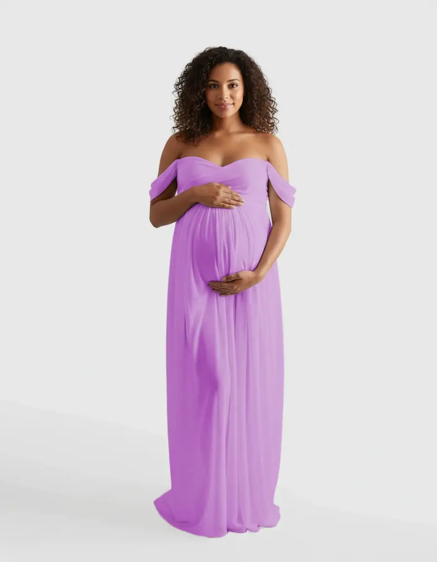 Smiling pregnant woman in a flowing lavender off-shoulder maternity photoshoot gown.