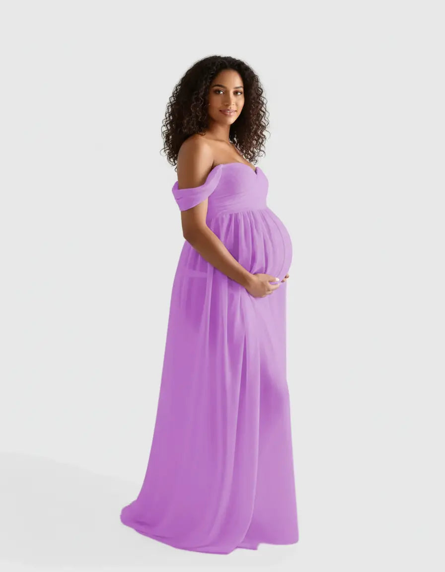Pregnant woman in a flowing, off-shoulder lavender maternity photoshoot gown.