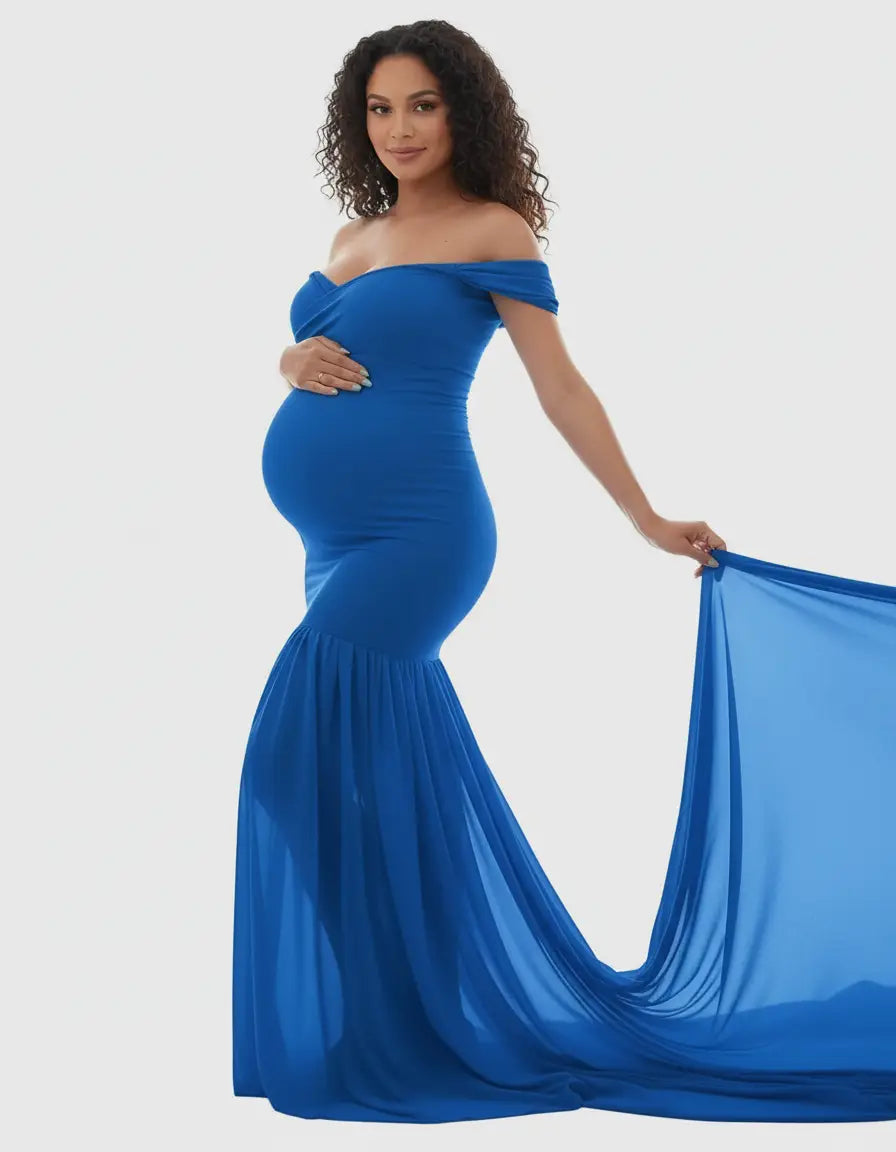 Pregnant woman in a royal blue off-shoulder flowy maternity gown with a mermaid hem and long train.