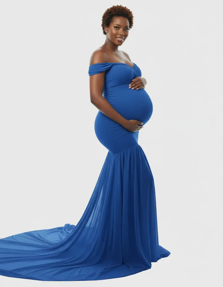 Pregnant woman in a royal blue off-shoulder flowy maternity gown with a long train.