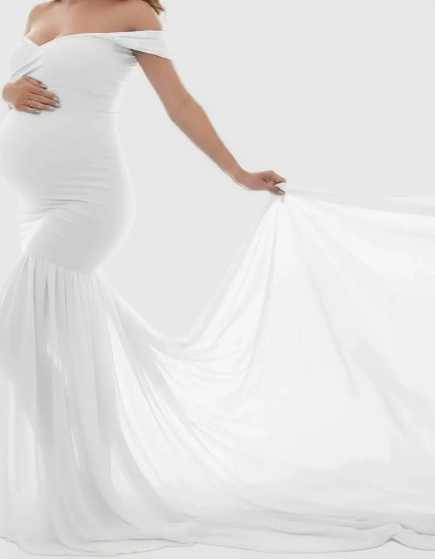 White off-shoulder flowy maternity gown with a fitted bodice and long, elegant train.