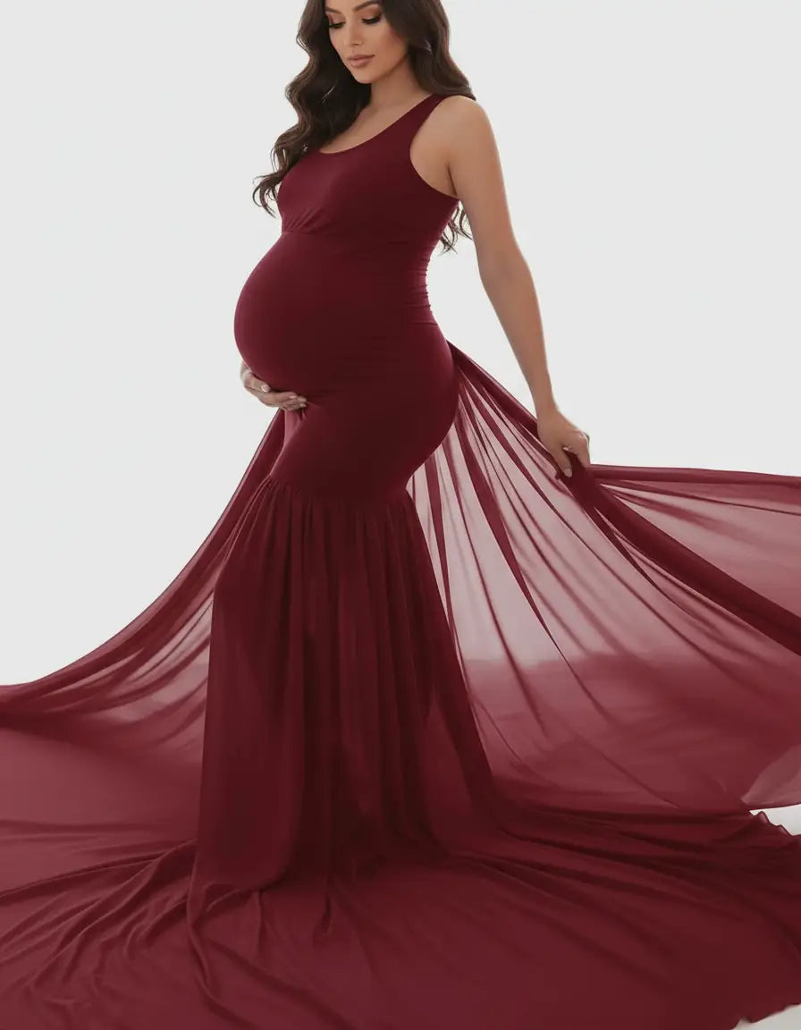 Maternity gown in deep red, sleeveless, with a flowing mermaid-style skirt and long sheer train.