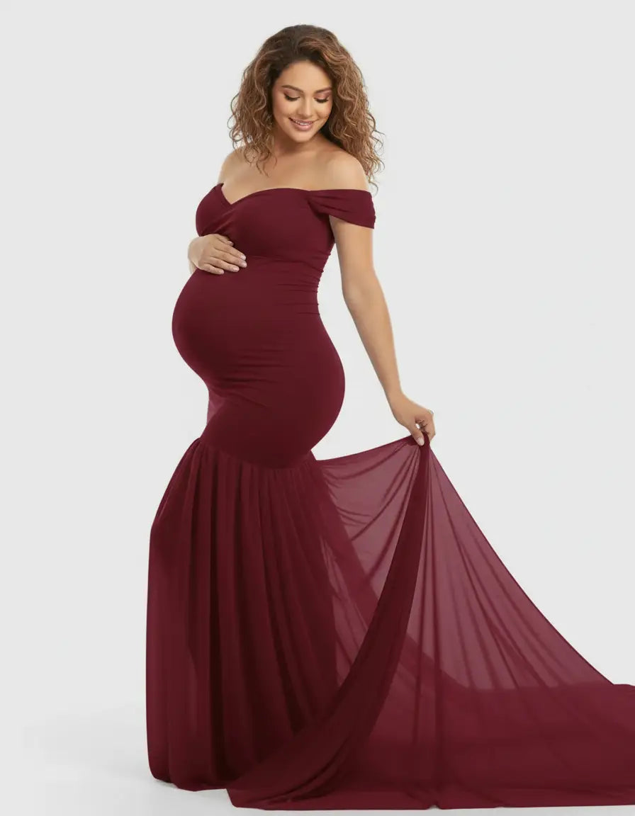 Maternity model in a flowy, off-shoulder burgundy gown with a mermaid-style skirt and long train.