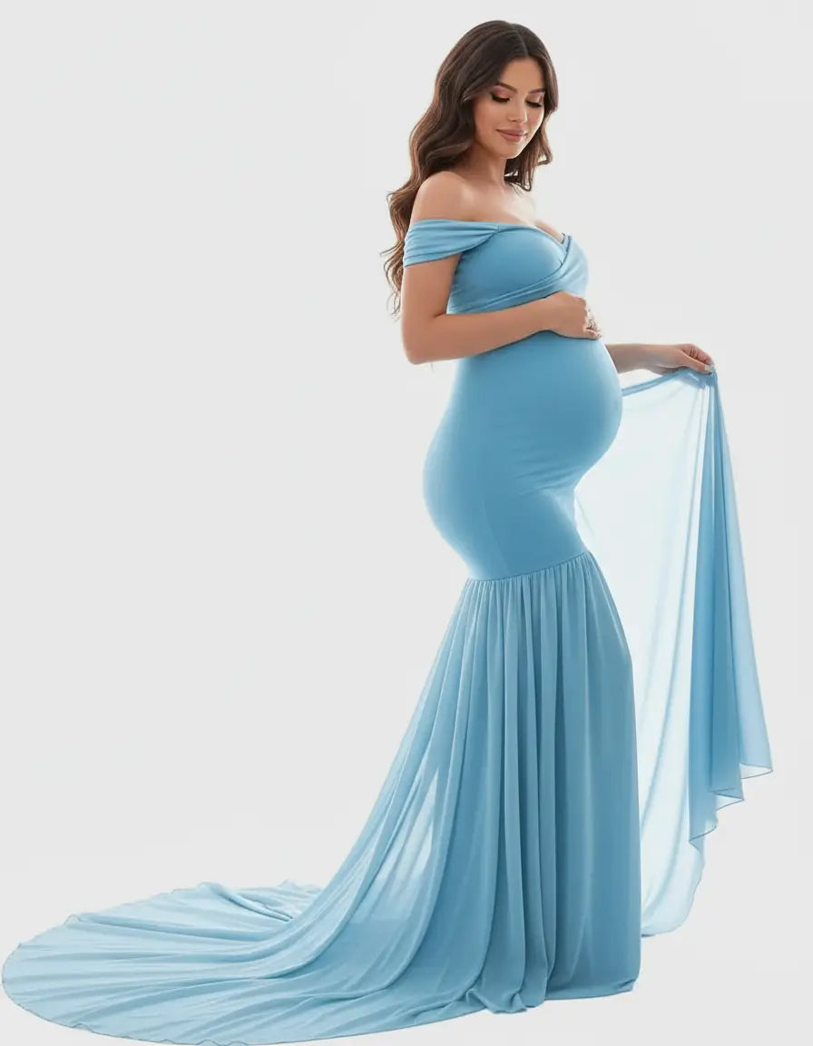 Pregnant woman in a light blue off-shoulder flowy maternity gown with a long train.