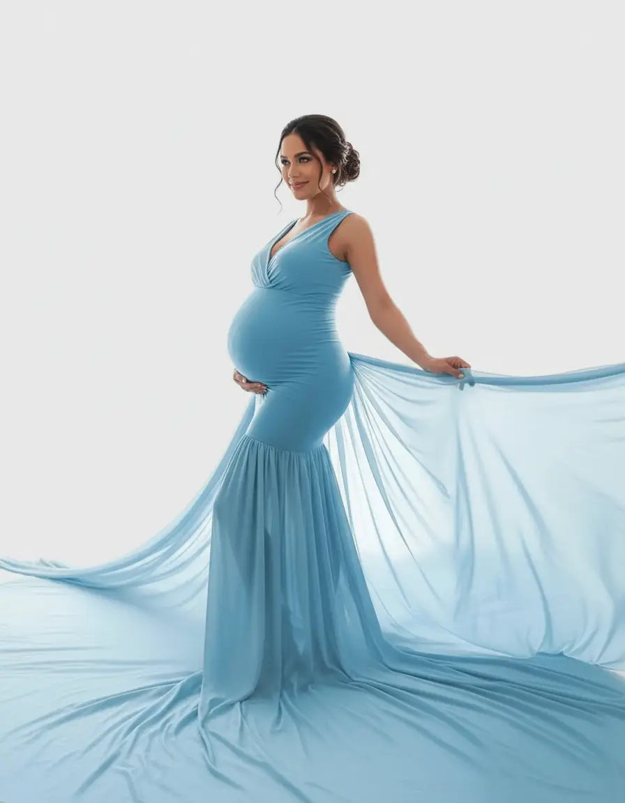 Pregnant woman in a flowy, light blue off-shoulder maternity gown with a V-neck and ruffled hem.