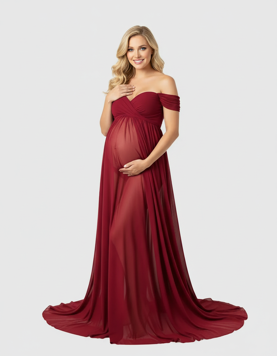 Blonde pregnant woman in a flowing, off-shoulder, laced, sheer dark red maternity maxi dress.