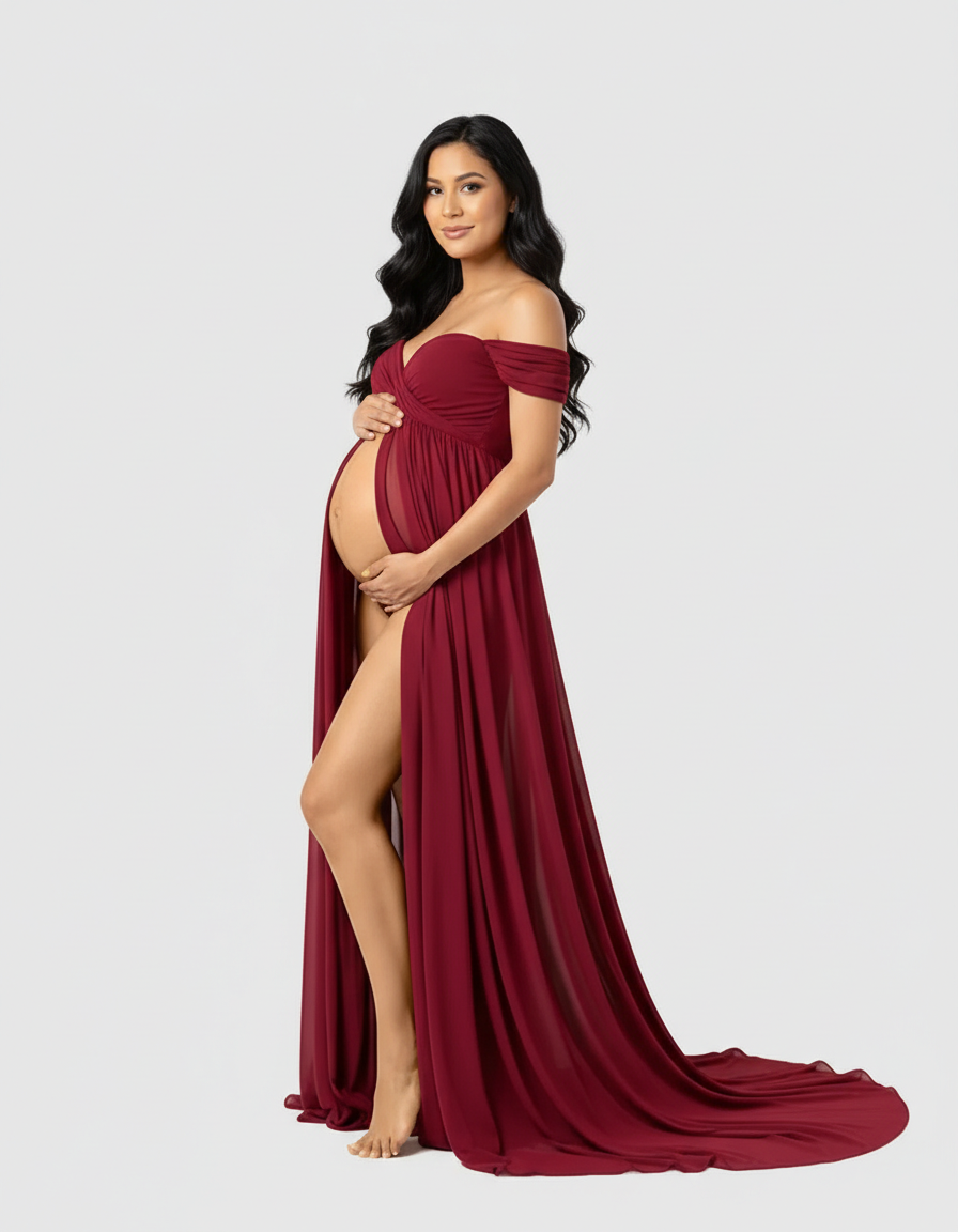 Pregnant woman in a flowing, off-shoulder burgundy maternity maxi dress with a thigh-high slit.