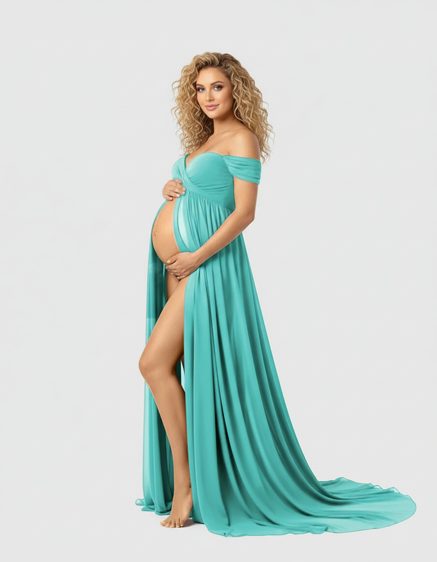 Pregnant woman in a flowing teal off-shoulder maxi dress with a thigh-high slit, cradling her bump.