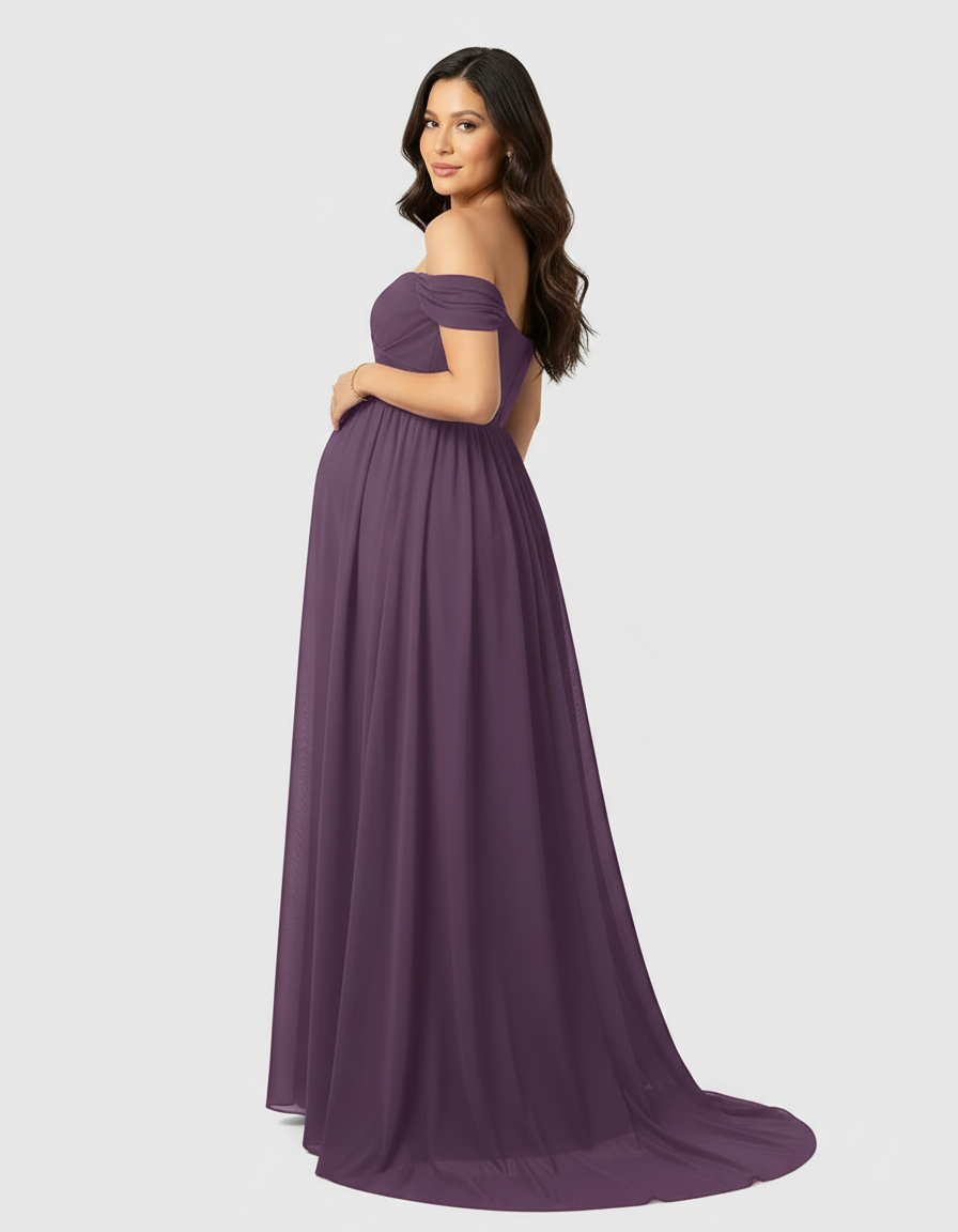 Pregnant woman in a flowing, off-shoulder plum maternity maxi dress with a long train.
