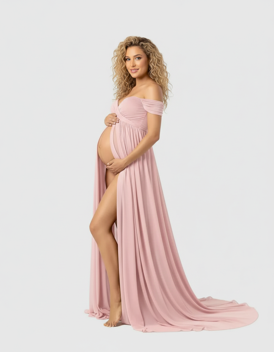 Blonde pregnant woman in a flowing, off-shoulder pink maternity maxi dress with a high slit.