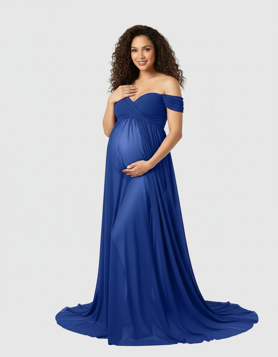 Maternity model in a flowing royal blue off-shoulder maxi dress with a sweetheart neckline, hands on baby bump.
