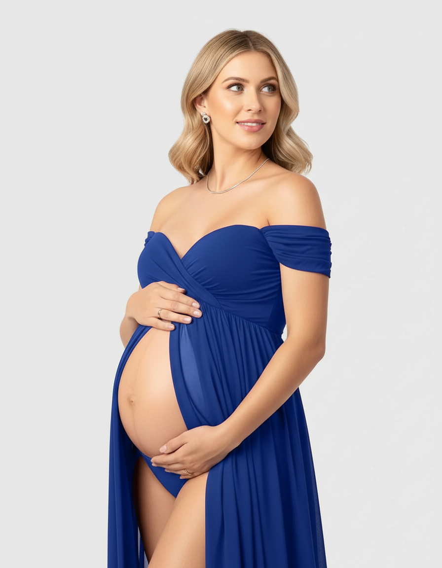 Blonde pregnant woman in a flowing royal blue off-shoulder maternity maxi dress with a sweetheart neckline.