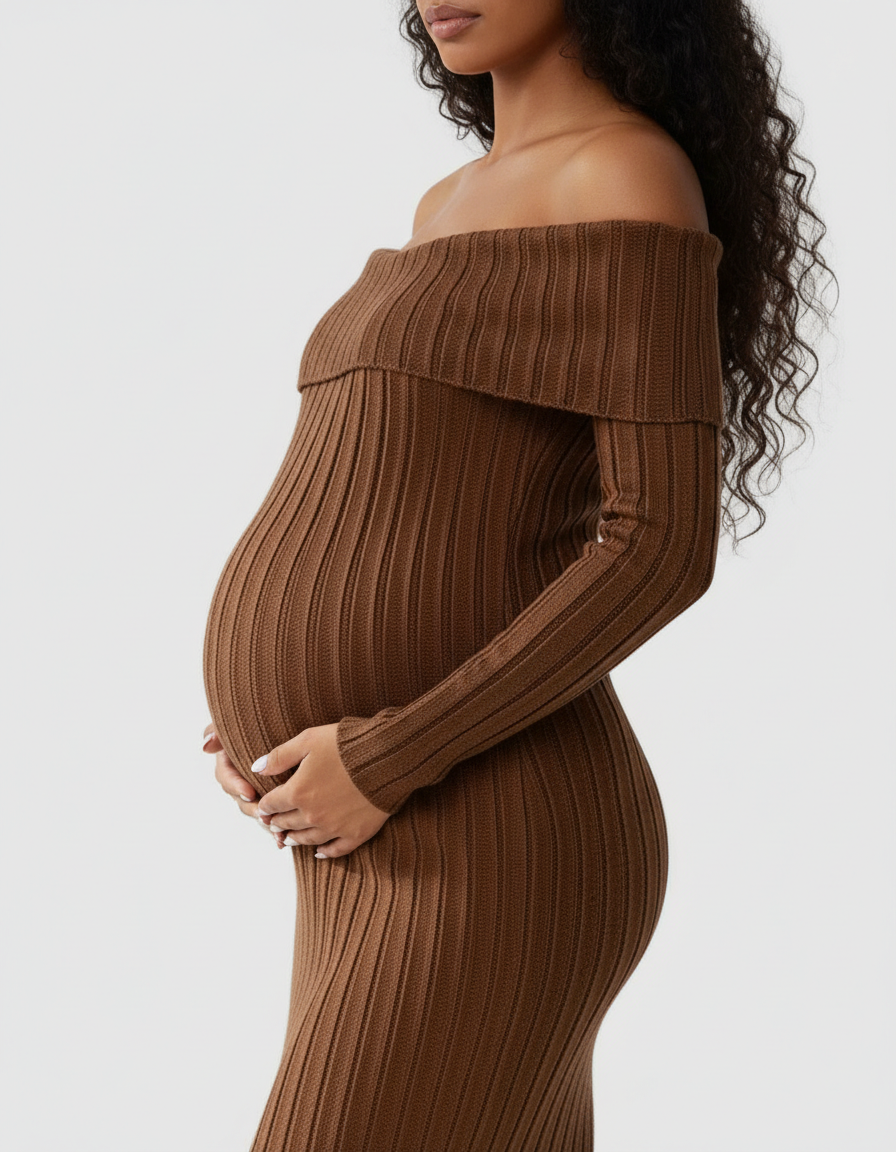 Maternity model in a brown off-shoulder ribbed knit midi dress, cradling her baby bump.