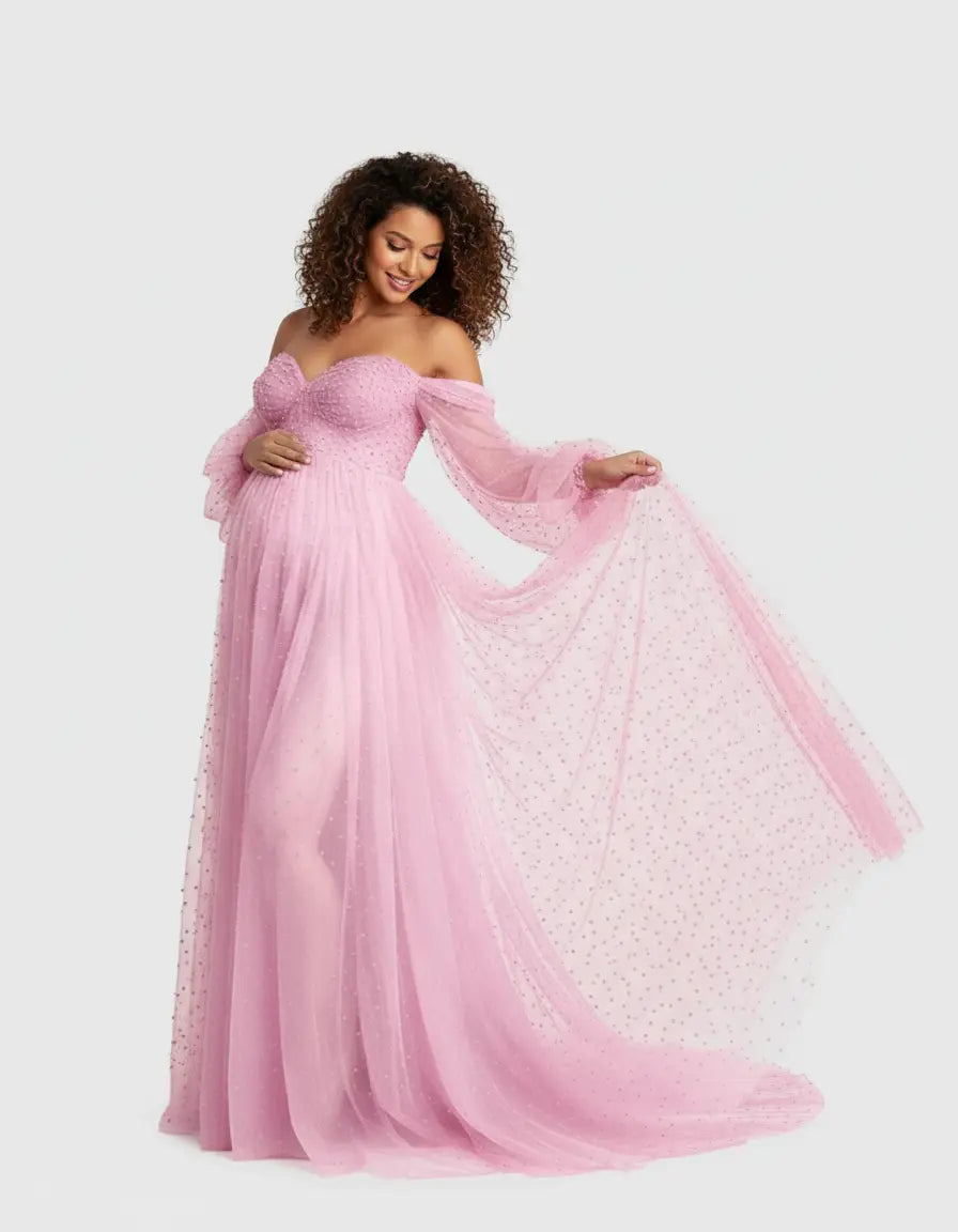 Pink off-shoulder tulle train maternity gown with long sleeves and delicate embellishments.