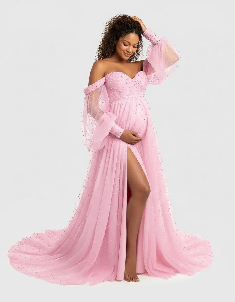 Pregnant woman in a pink off-shoulder tulle train maternity gown with puffed sleeves and a high slit.