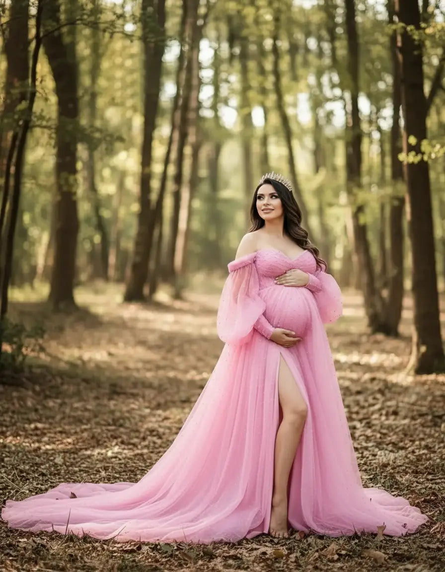 Pregnant woman in a pink off-shoulder tulle train maternity gown with a thigh-high slit, wearing a crown in a forest.