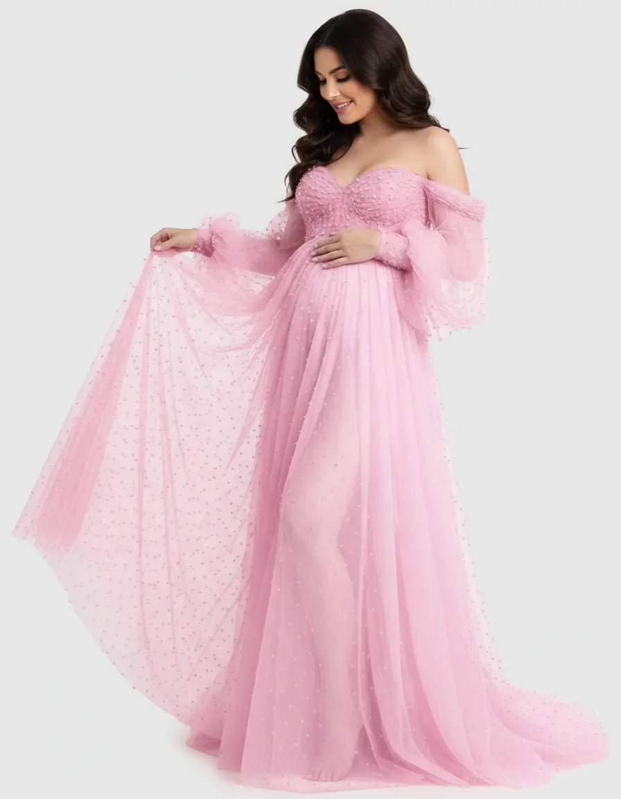 Pink off-shoulder tulle train maternity gown with long bell sleeves and delicate polka dots.