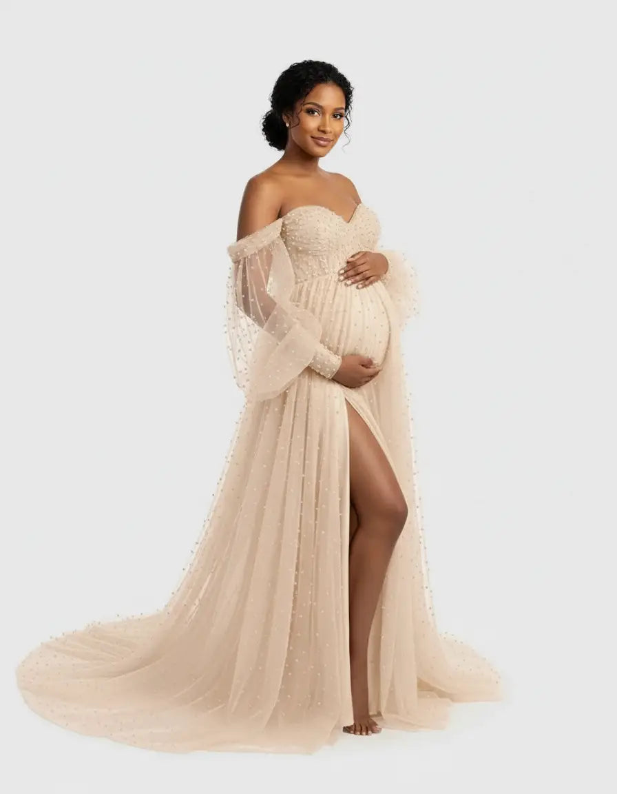 Maternity gown: Off-shoulder tulle train, champagne color, pearl embellishments, long sheer sleeves, high slit.