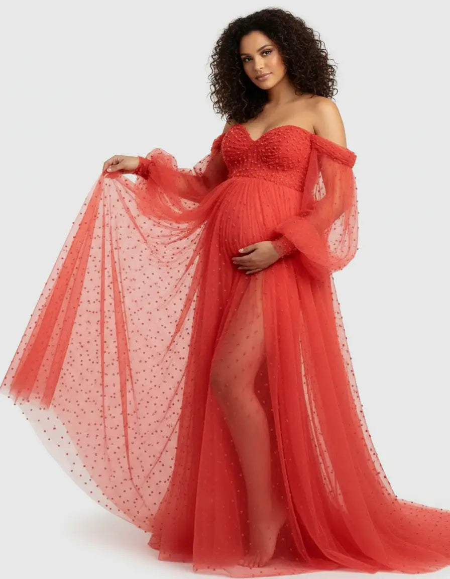 Maternity gown: off-shoulder, red tulle with pearl embellishments, long sheer sleeves, and a high slit.