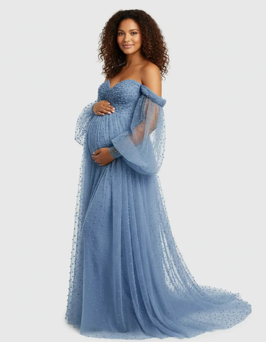 Maternity gown: blue off-shoulder tulle with train, long sheer sleeves, and textured polka dots.
