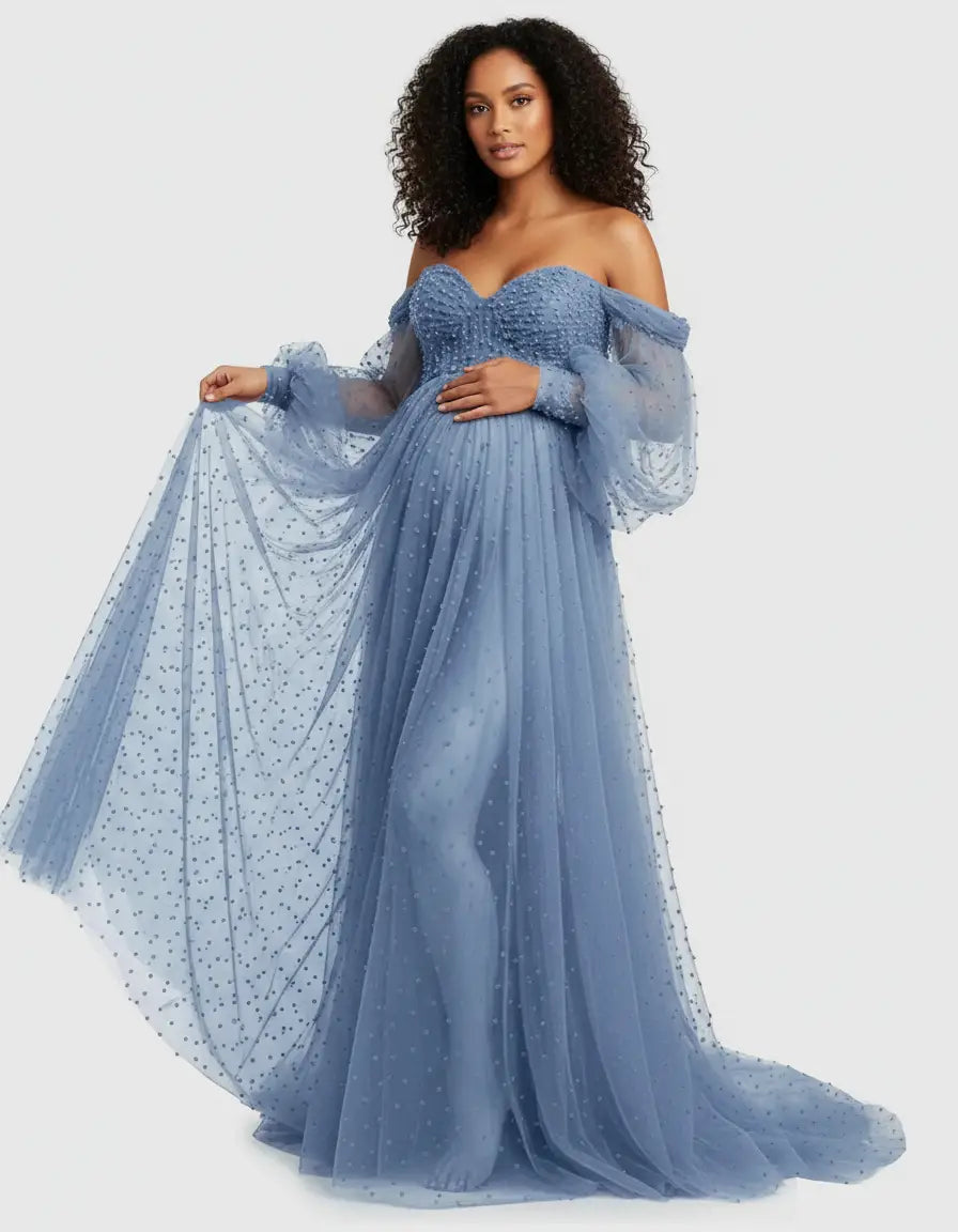 Off-shoulder blue tulle train maternity gown with long balloon sleeves and subtle polka dots.