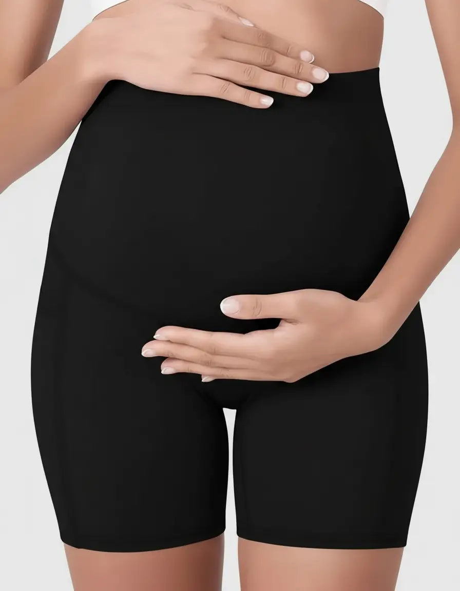 Black over-belly maternity bike shorts with pockets, shown on a pregnant woman's torso.