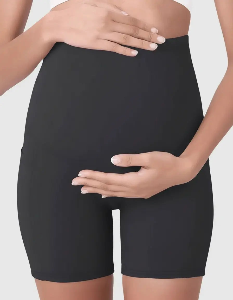 Black over-belly maternity bike shorts with pockets, worn by a pregnant woman.