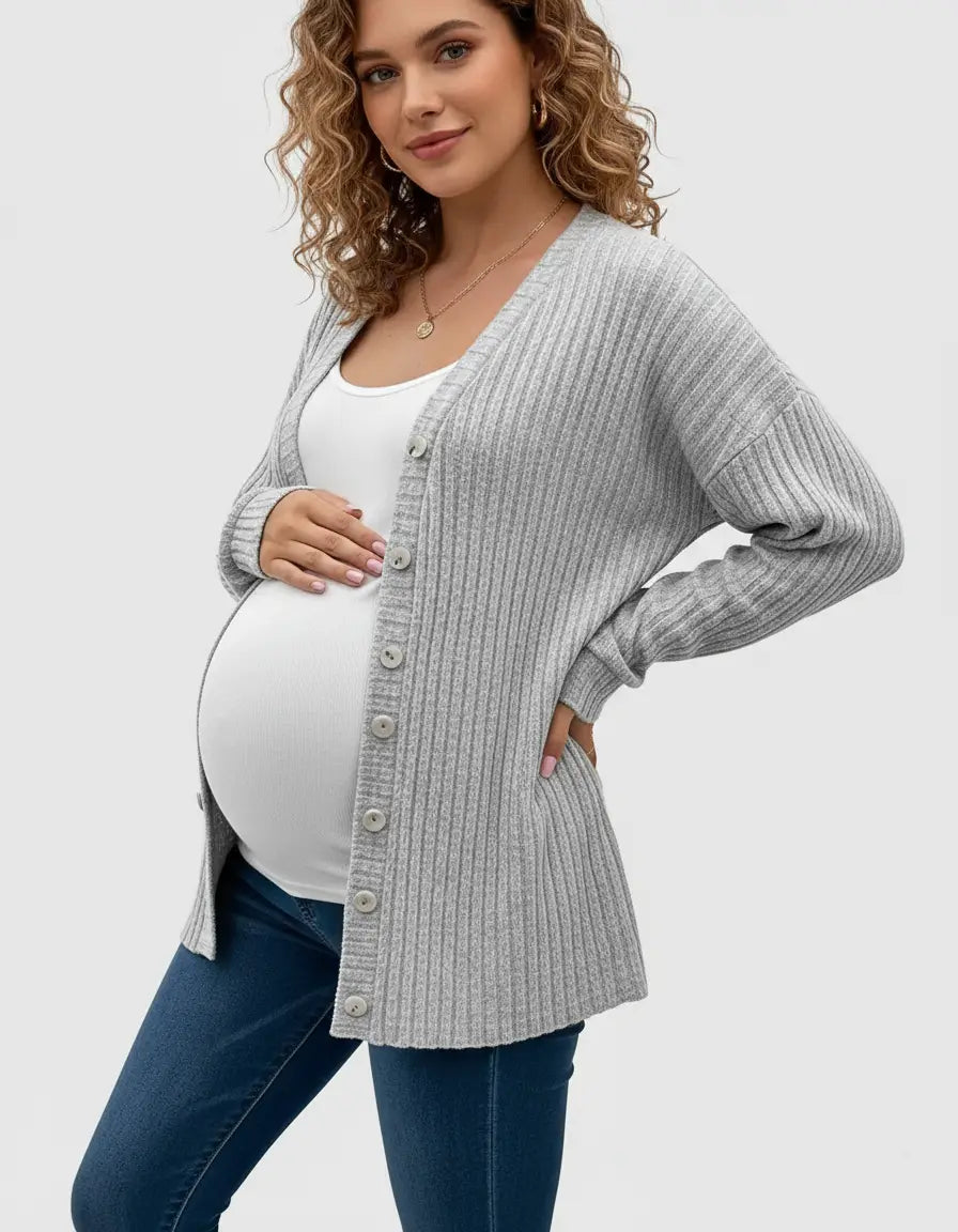 Pregnant woman wearing a light gray ribbed button-front drop shoulder maternity top over a white tank top and jeans.