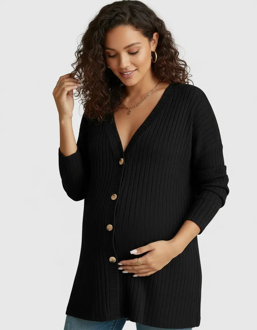 Pregnant woman in a black ribbed button-front drop shoulder maternity top, gently touching her belly.