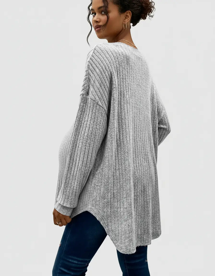 Woman wearing a light gray ribbed button-front drop shoulder maternity top with a relaxed fit.