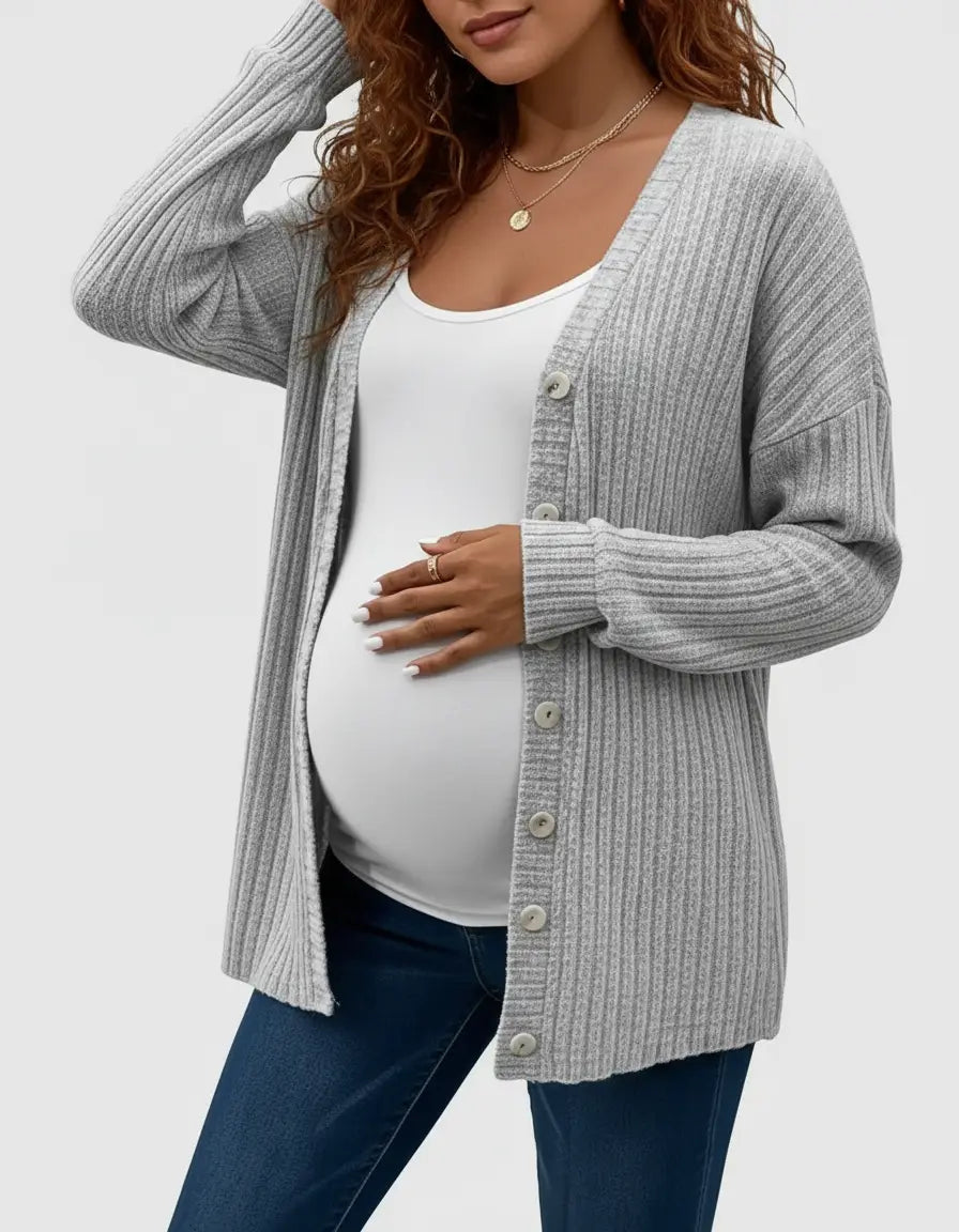 Pregnant woman wearing a gray ribbed button-front drop shoulder maternity cardigan over a white tank top.