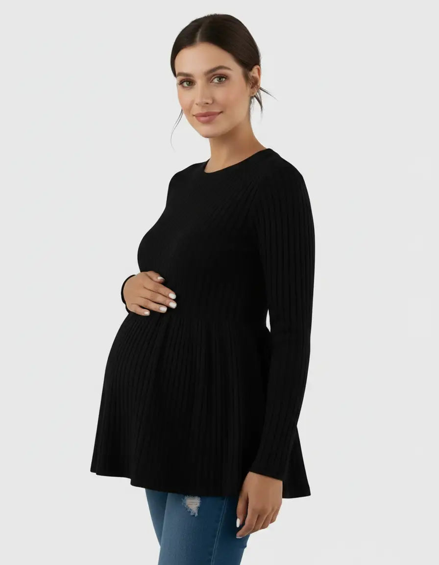 Black ribbed knit maternity top with long sleeves and ruffle hem, worn by a pregnant woman.