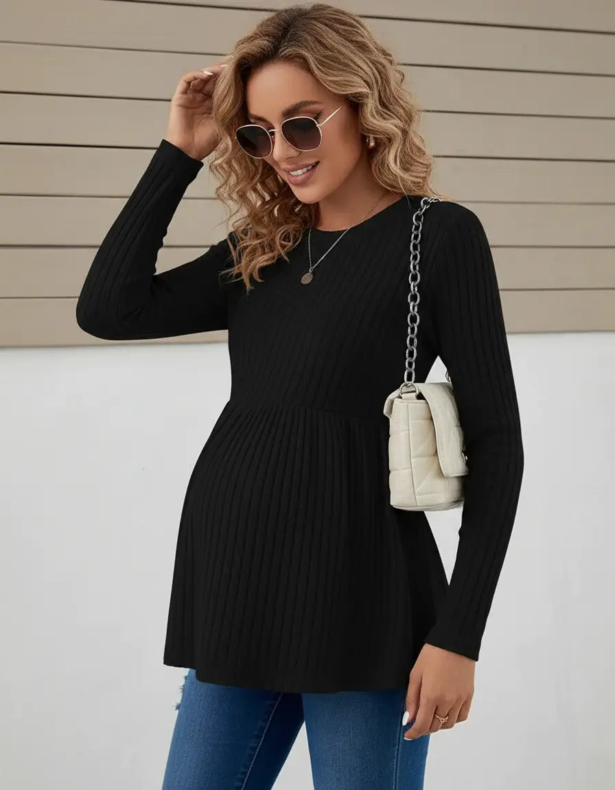 Black ribbed knit maternity top with long sleeves, ruffle hem, and round neck.