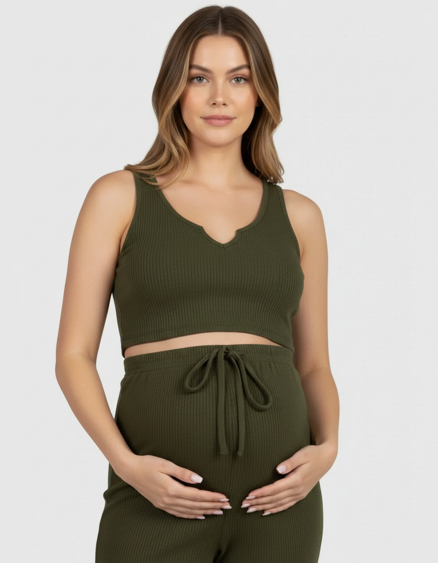 Pregnant woman in a green ribbed tie-waist camisole and slim-leg maternity set.