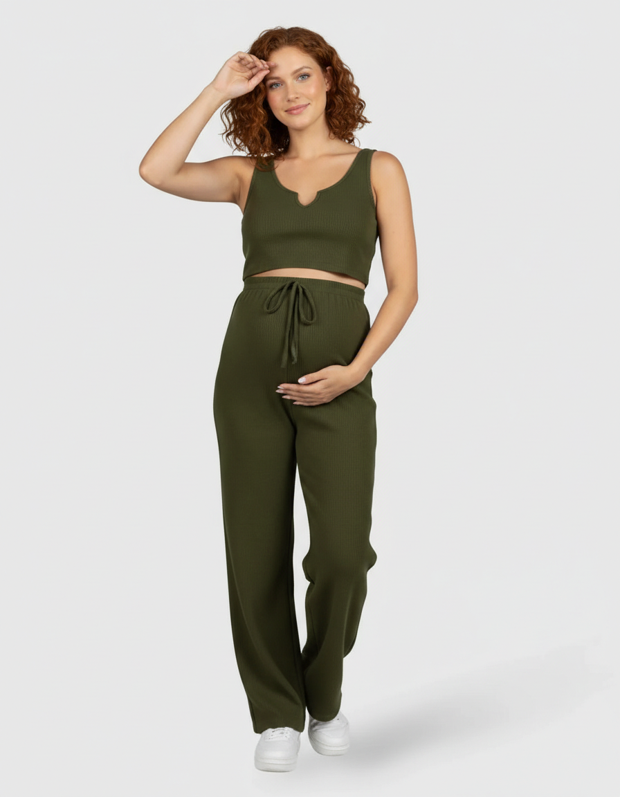 Pregnant woman in a green ribbed tie-waist camisole and slim-leg maternity set.