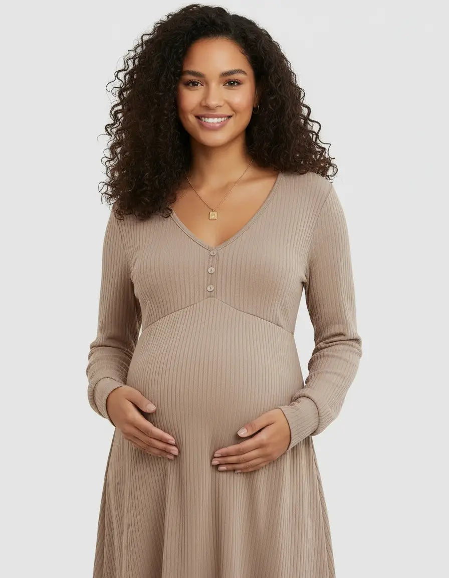 Smiling pregnant woman in a beige ribbed V-neck maternity top with long sleeves and button details.