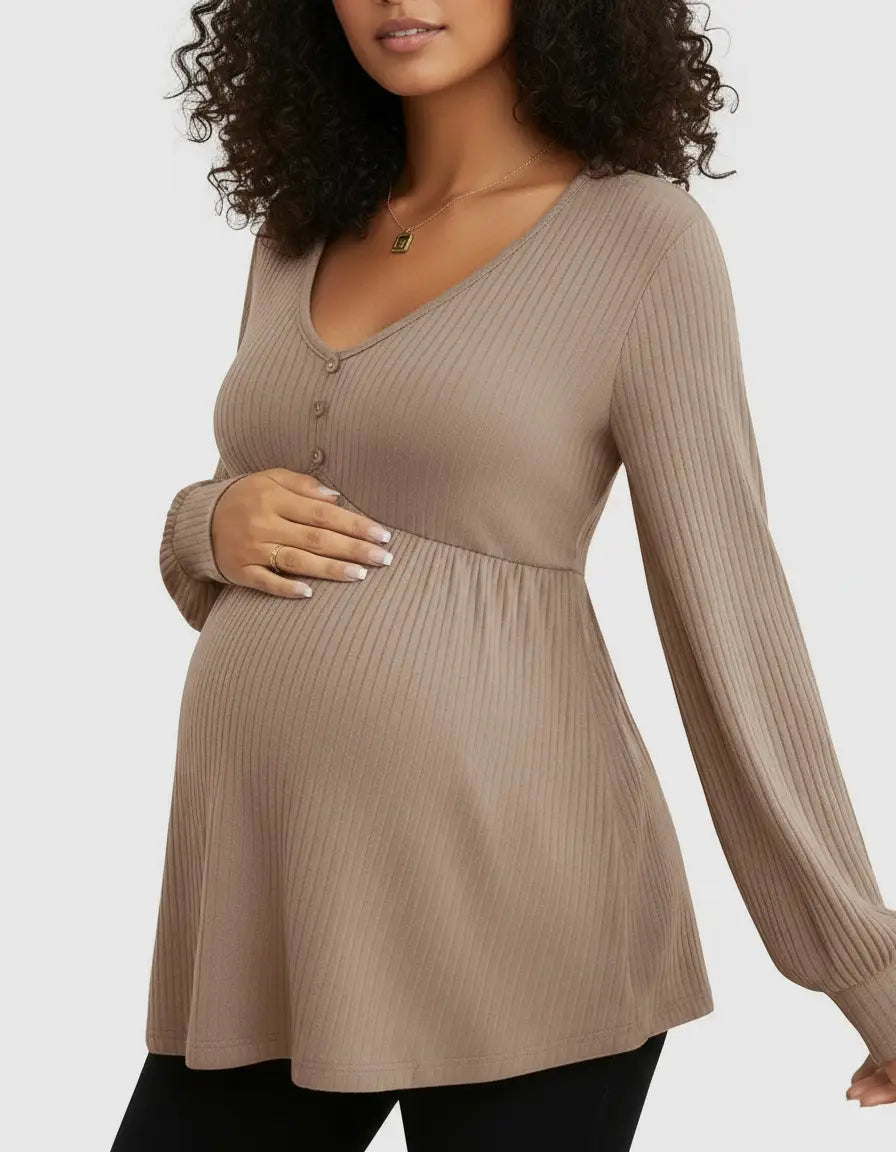 Pregnant woman in a brown ribbed V-neck maternity top with long sleeves and button detail.