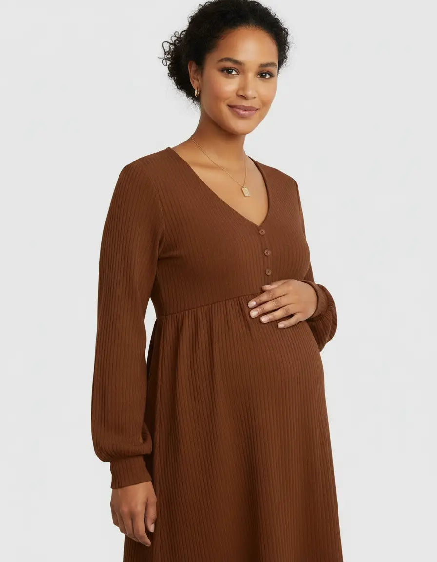 Smiling pregnant woman in a brown ribbed V-neck maternity top with long sleeves and button details.