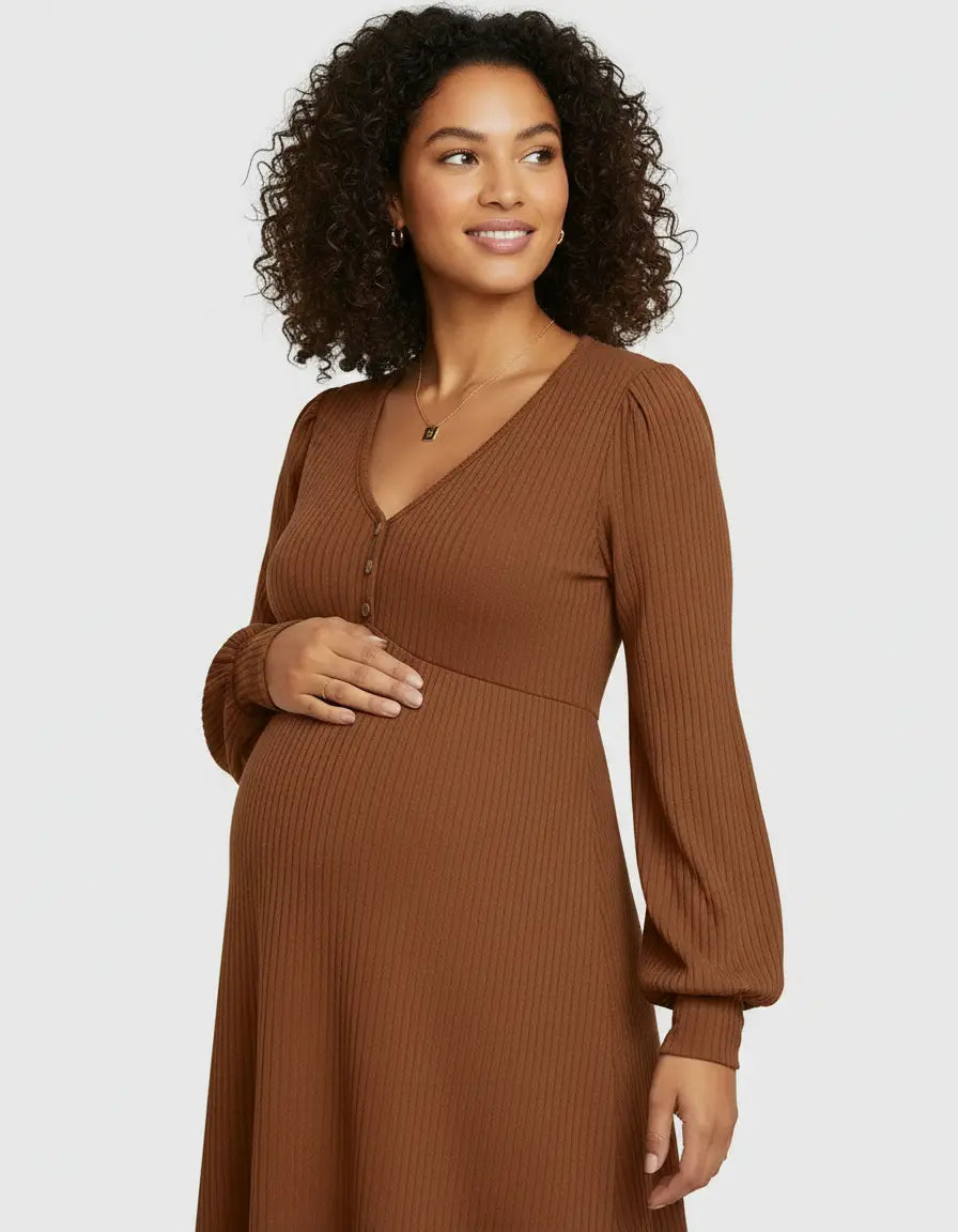 Smiling pregnant woman in a brown ribbed V-neck maternity dress with long sleeves and button detail.