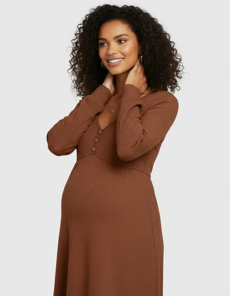 Smiling pregnant woman in a brown ribbed long-sleeve V-neck maternity top with button details.