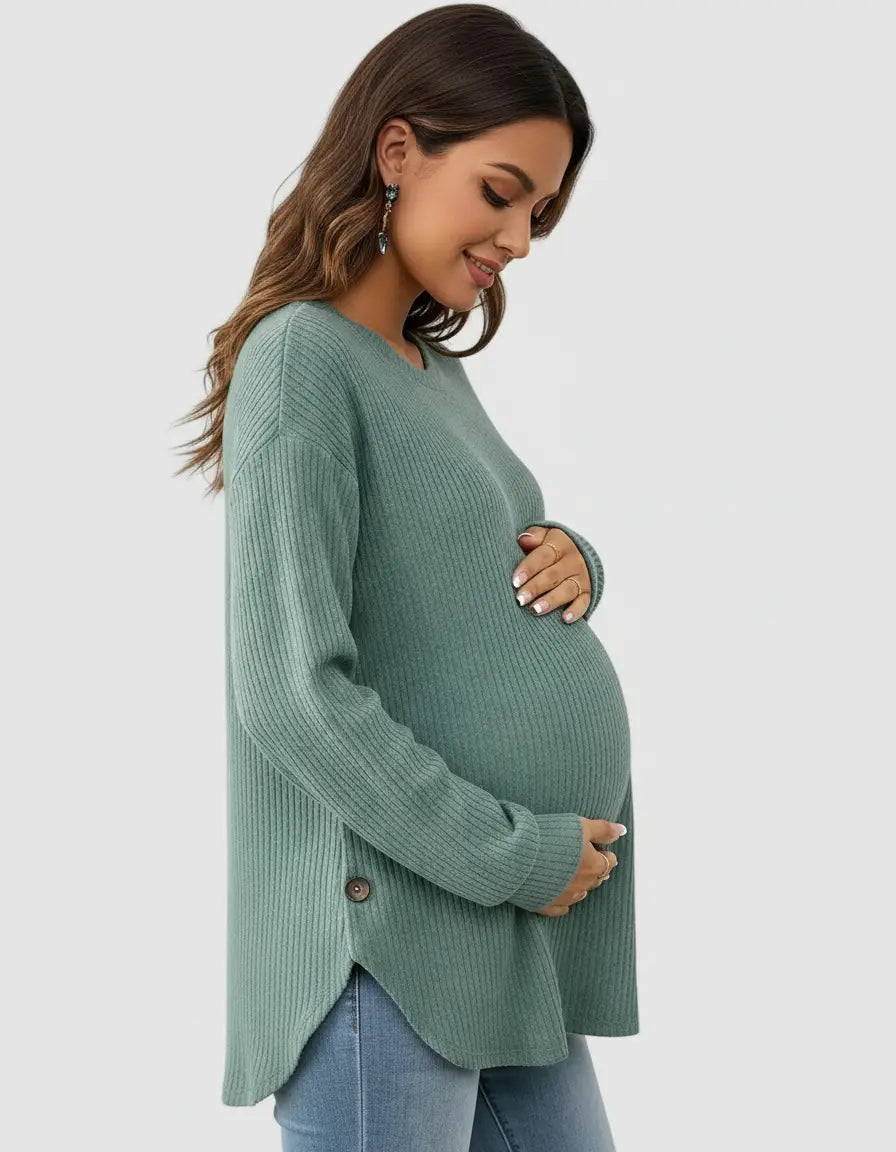 Pregnant woman in a soft-knit, relaxed-fit sage green maternity sweatshirt with side buttons.