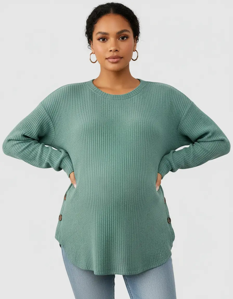 Woman in a soft-knit, relaxed-fit sage green maternity sweatshirt with ribbed texture and side buttons.