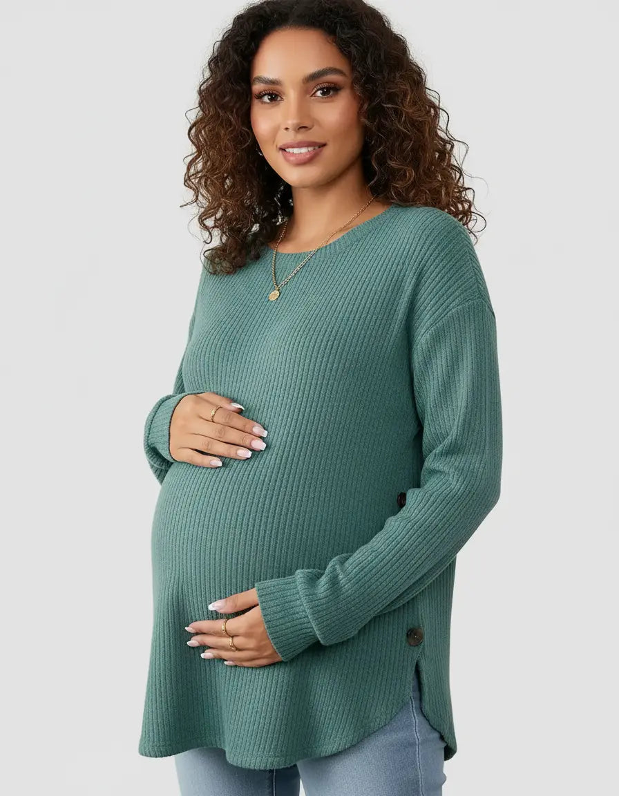 Smiling pregnant woman in a soft-knit, relaxed-fit teal maternity sweatshirt with side buttons.