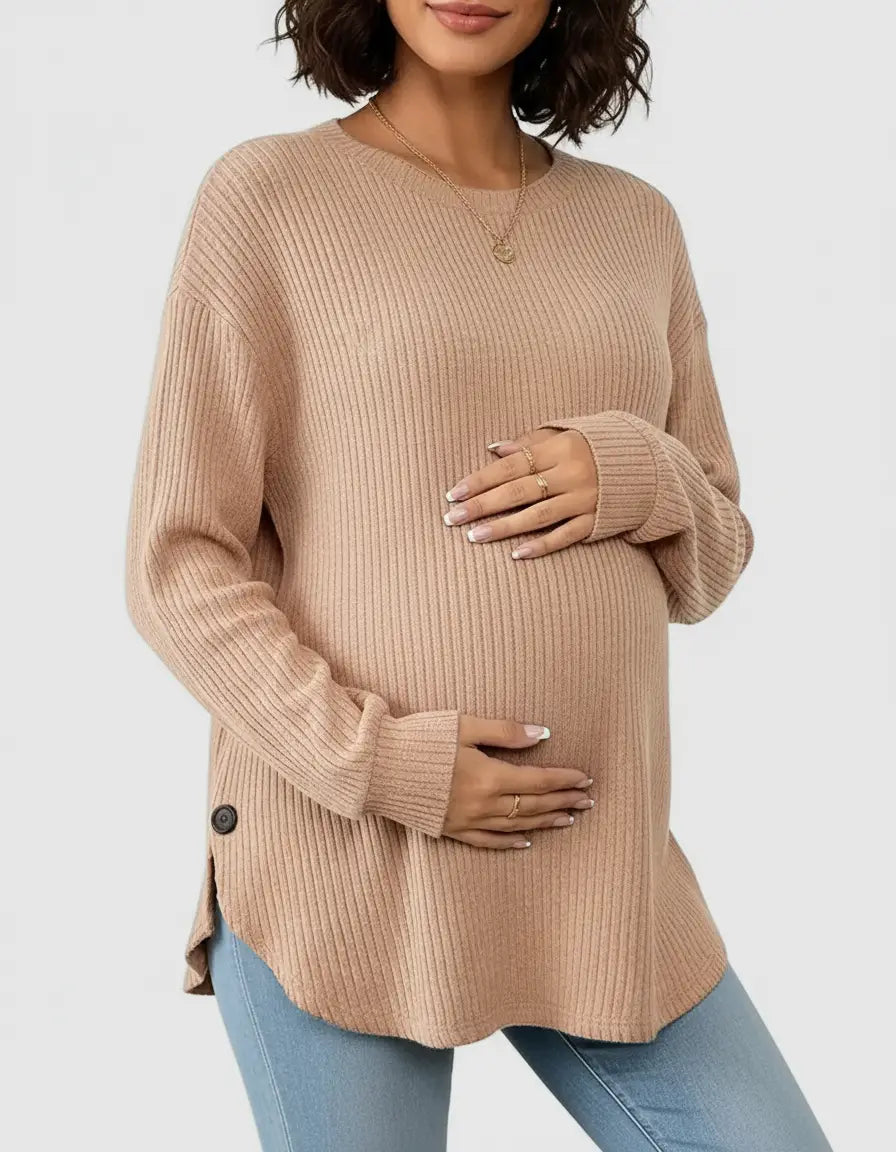 Pregnant woman wearing a soft-knit, relaxed-fit beige maternity sweatshirt with side buttons.