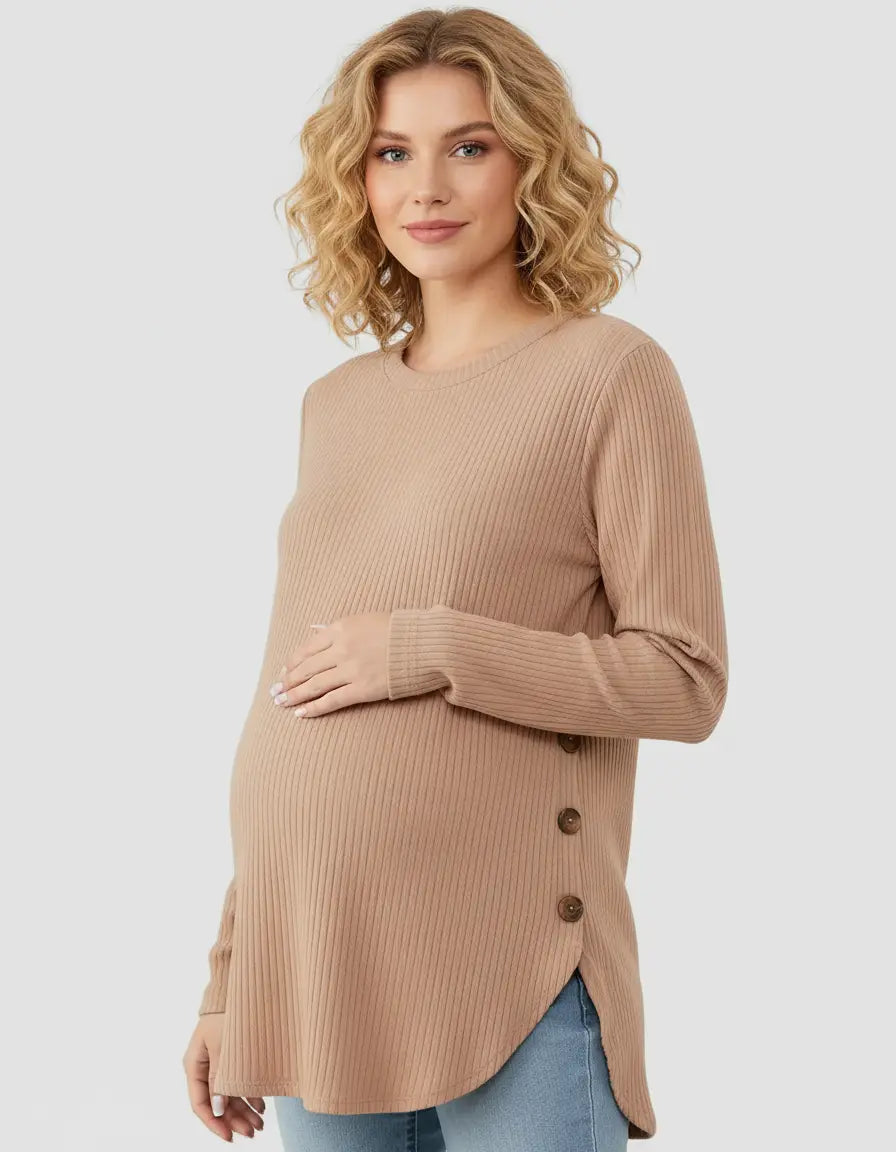Pregnant woman in a beige soft-knit relaxed-fit maternity sweatshirt with side buttons.