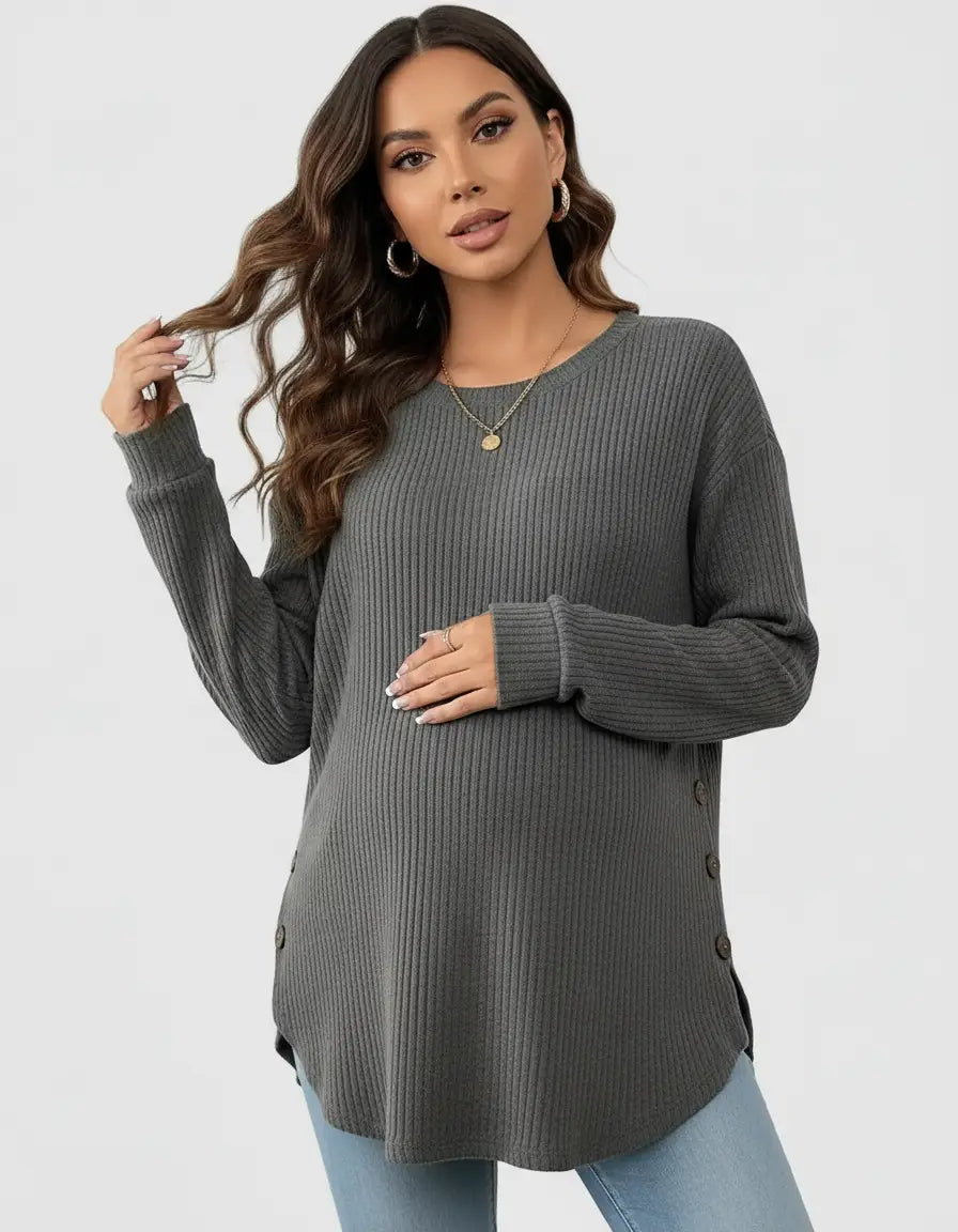 Pregnant woman in a gray soft-knit relaxed-fit maternity sweatshirt with side buttons.