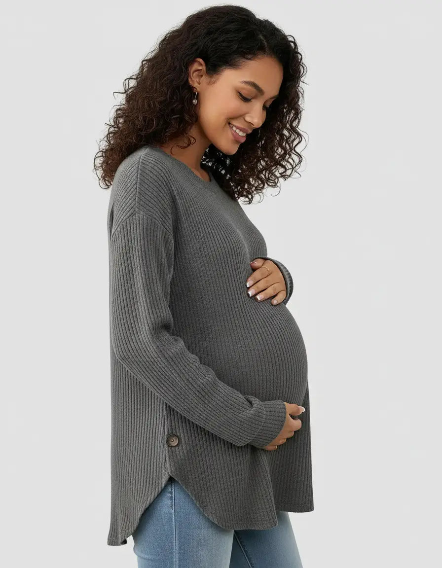 Pregnant woman in a charcoal gray soft-knit relaxed-fit maternity sweatshirt with side buttons.
