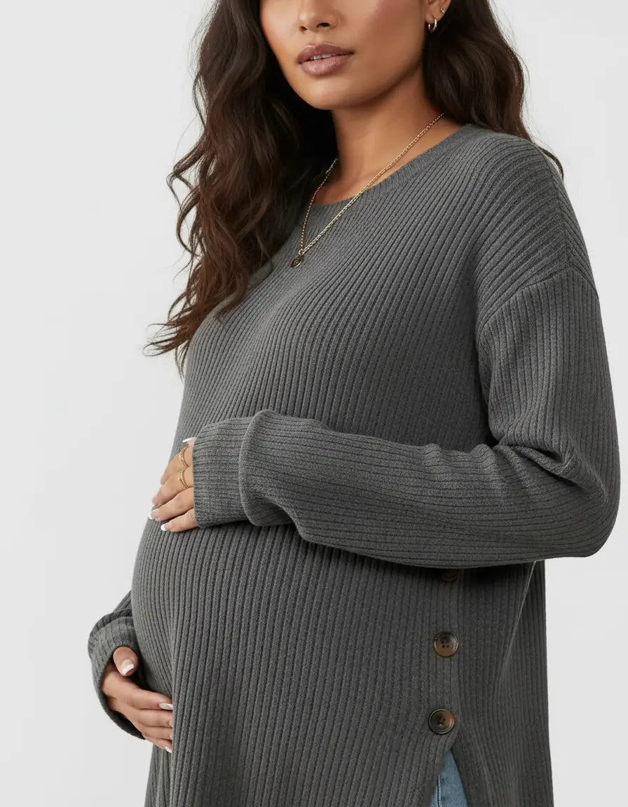 Pregnant woman in a dark gray soft-knit relaxed-fit maternity sweatshirt with side buttons.
